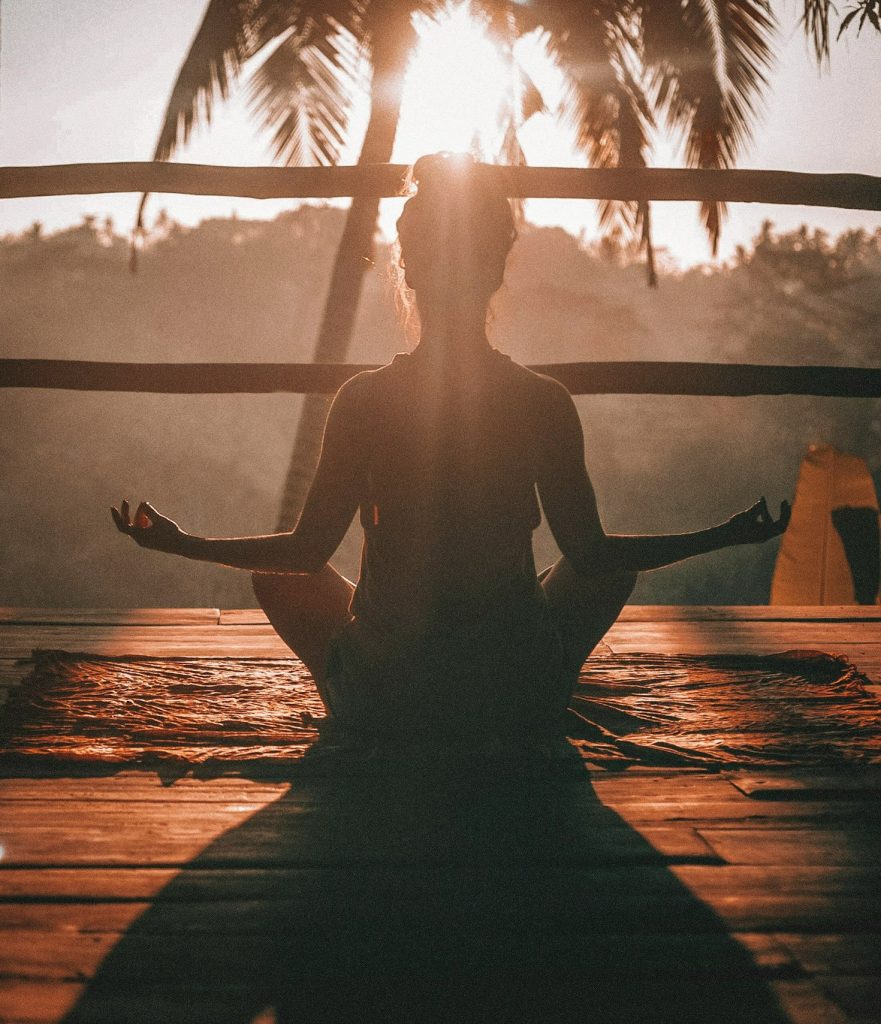 woman meditating during sundown
